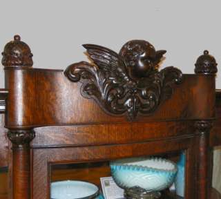 Antique Oak China Cabinet Curio with carved Cherub in the crest  
