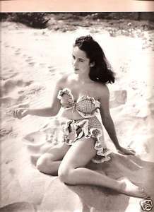 ELIZABETH TAYLOR IN BATHING SUIT BEACH PHOTO PRINT AD  