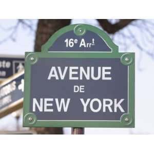  A Blue and Green Street Sign with White Lettering 