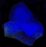 Fluoresces blue under LW UV light