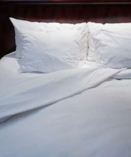 Soft white sheets on a comfortable bed