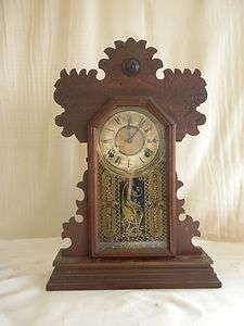   ginger bread mantle striking clock,running,gold decorated glass  