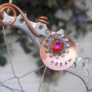 Completed with a concave hand stamped copper disc dream, gear and 