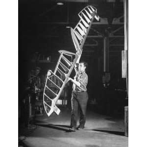  Worker Carrying Elevator Frame, at Curtiss Wright Plant 