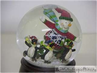 musical hand painted glitter globe with a church and townspeople 